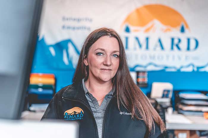 Woman at Simard Automotive office desk.